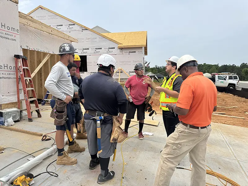 Construction workers talking on job site