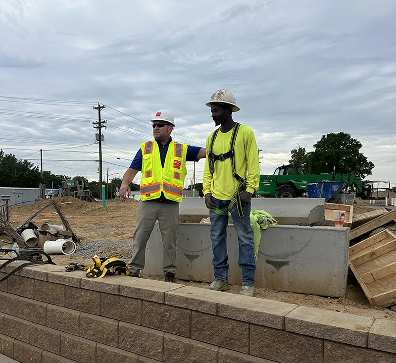 Two construction workers on job site