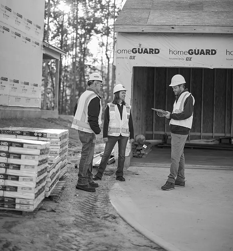 Three construction workers on jobsite